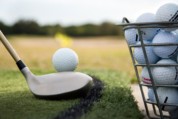 Golf ball and bucket on range 